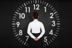 woman in front of clock