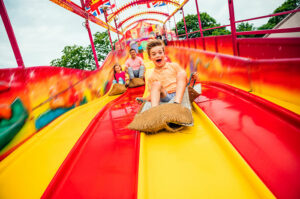 kid on fair slide