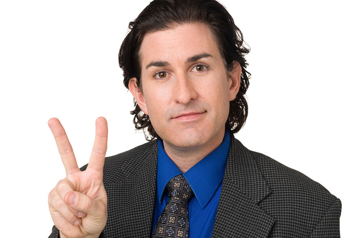 man holding up peace sign