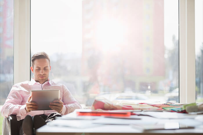 relaxed businessman on his work tablet