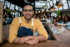 owner in yellow checker shirt